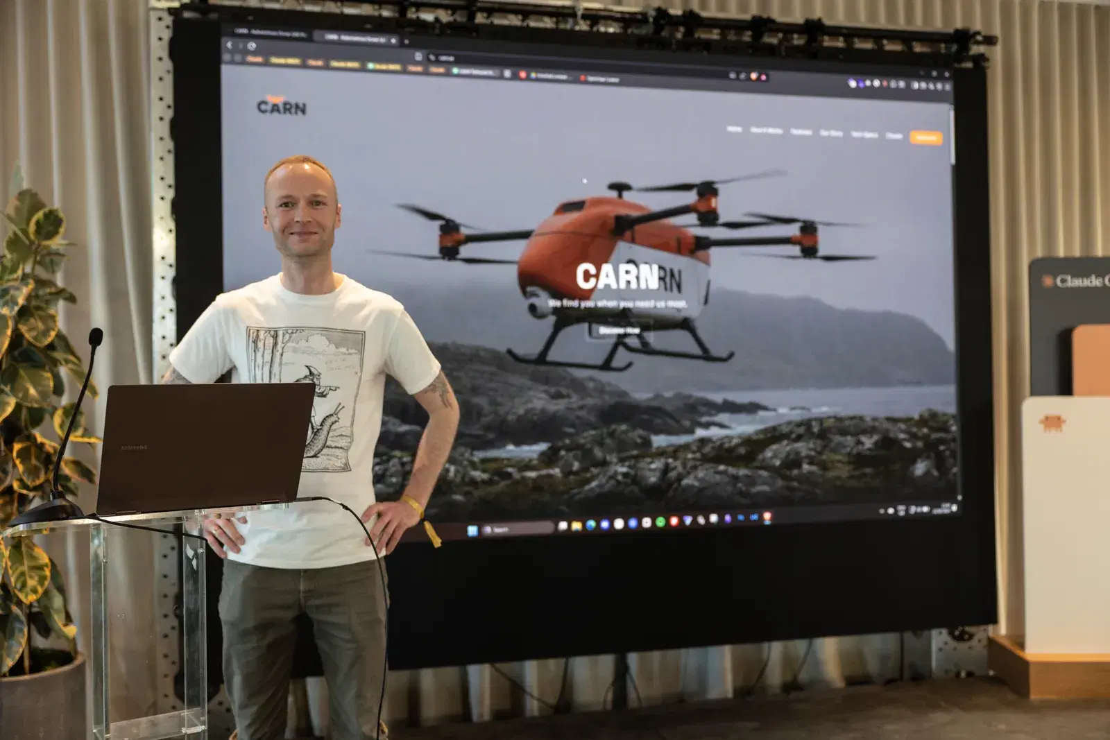 Kevin Collins presenting Carn.ie autonomous drone search and rescue platform on stage at Claude Code's 1st birthday party in San Francisco